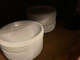 a lot of plates that are sitting on a shelf