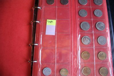 a lot of coins in the case on the table