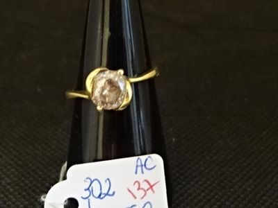 une bague ornée d'un diamant au sommet d'un cône noir