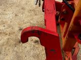 a red piece of machinery that is sitting on the ground