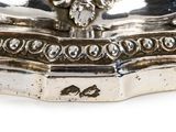 a silver figurine with a crown on top of it