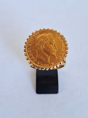 an image of a gold coin on a black stand