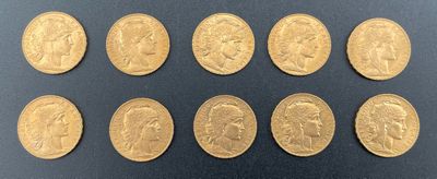a close up of a bunch of gold coins on a black surface