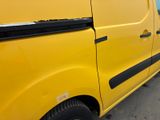 a yellow van parked on the side of the road