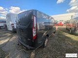 the rear end of a black van parked in a parking lot