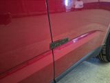 a close up of a car door handle with a sticker on it