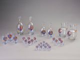 a lot of glass bottles and glasses sitting on a table