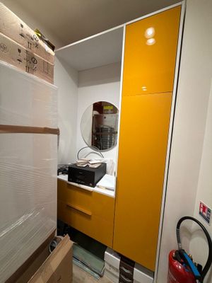 a refrigerator in a room with a lot of boxes on the floor