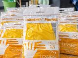 several bags of cleaning supplies sitting on top of a wooden table