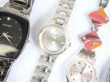several watches are lined up on a white surface with a white background