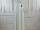 a photo of a white dress on a mannequin stand