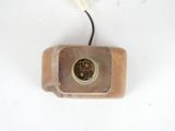 a small clock that is on a white surface