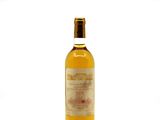an image of a bottle of wine sitting on top of a white surface