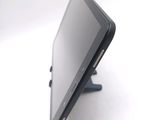 a tablet computer sitting on a stand on a white surface