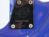 the back of a blue electric guitar with a black fretset