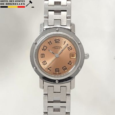 a silver watch with a pink dial on it