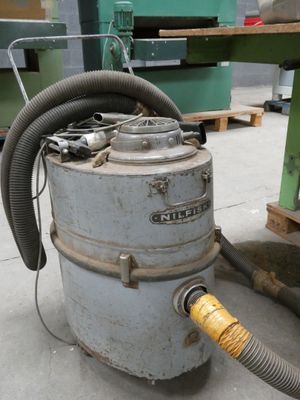 a large industrial dust collector sitting on the floor