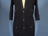an image of a black cardigan sweater dress on a mannequin stand