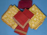 four pieces of red and yellow cloth on a blue surface