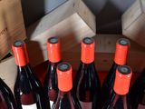 several bottles of red wine are lined up in a wooden crate