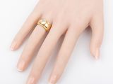 an image of a woman ' s hand with a gold ring on it