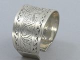 an image of a silver ring with a design on it