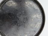 an old frying pan on a table with a white background