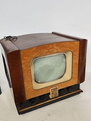 a small television sitting on top of a white table
