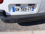 a small white car parked on the side of the road