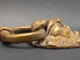 pair of bronze figurines of a woman and a man