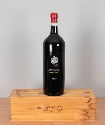 a bottle of wine sitting on top of a wooden box