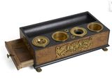 a wooden box with three brass cups in it