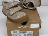baby shoes in a box on a white surface with a white background