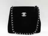 un sac à main noir muni d'une chaîne et d'un fermoir argenté