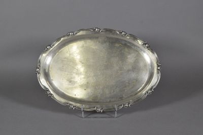 a silver plate with a decorative design on the rim