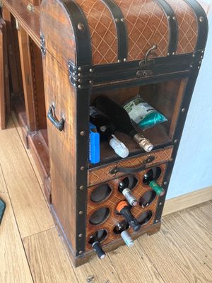 a wooden chest with many bottles of wine on it