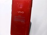 the back of a red cell phone with a display on it