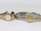 two ladies ' s wrist watches are sitting side by side on a white surface