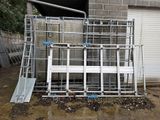 a pile of windows and a ladder in front of a building