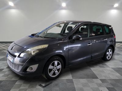 a picture of a grey car parked in a garage