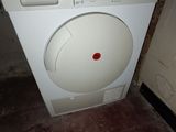 a washing machine that is sitting in the corner of a room