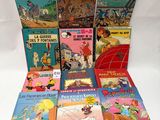 several children ' s books are lined up on a white surface