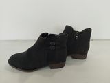 une paire de bottines noires posées sur une surface blanche