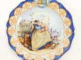 a plate with a picture of a woman sitting on a bench