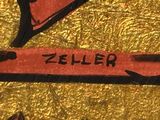 a picture of a gold plate with a red and black arrow