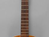 a close up of an acoustic guitar on a gray background
