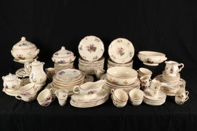 many different types of porcelain dishes and cups on a table
