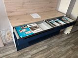 a desk with a book and magazines on it