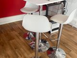 a white table with two chairs and a computer on it