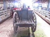 a horse drawn carriage that is in a barn